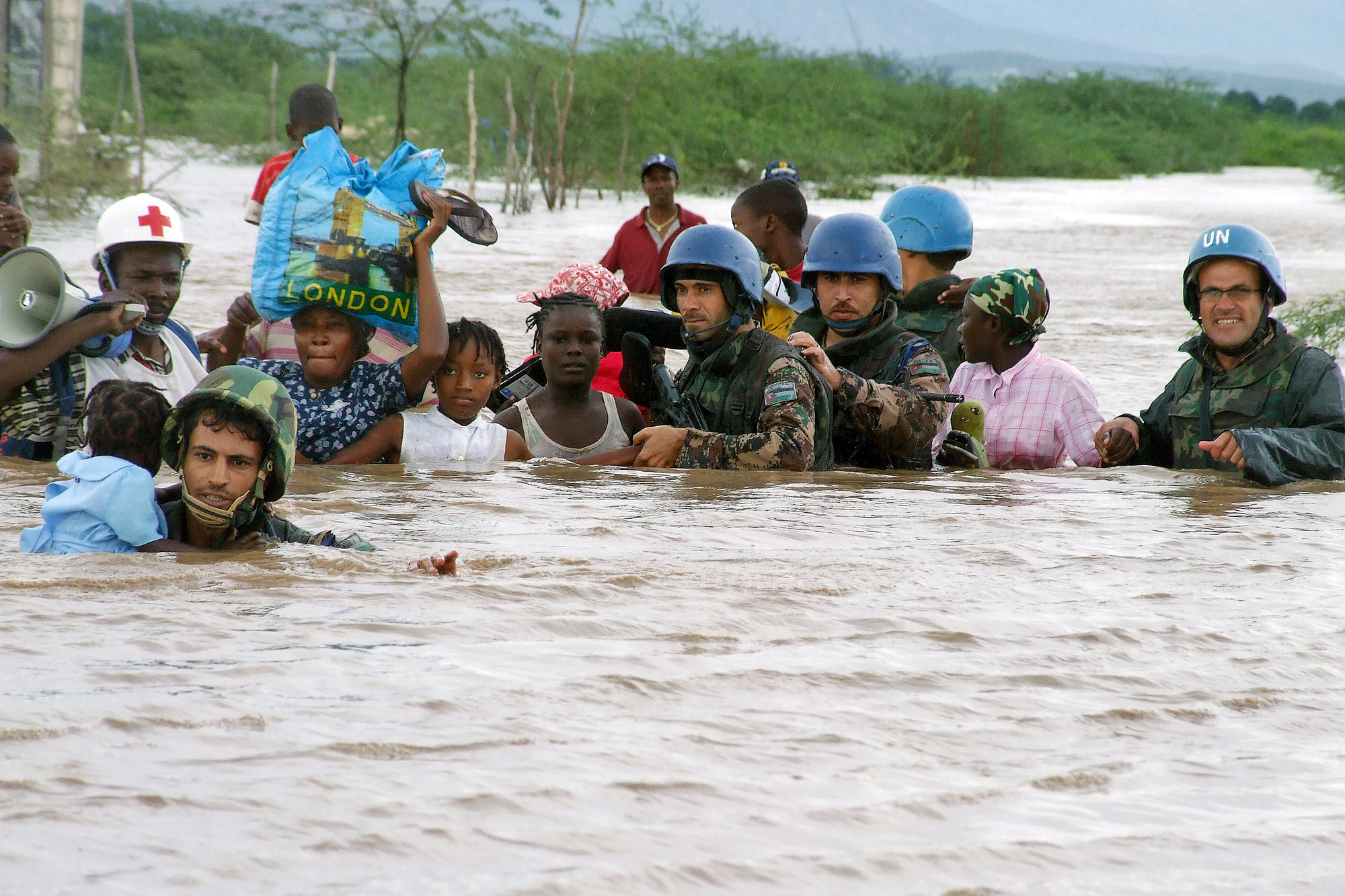 Members of the Jordanian battalion of the United Nations Stabilization Mission in Haiti (MINUSTAH) rescue children from an orphanage destroyed by hurricane "Ike".