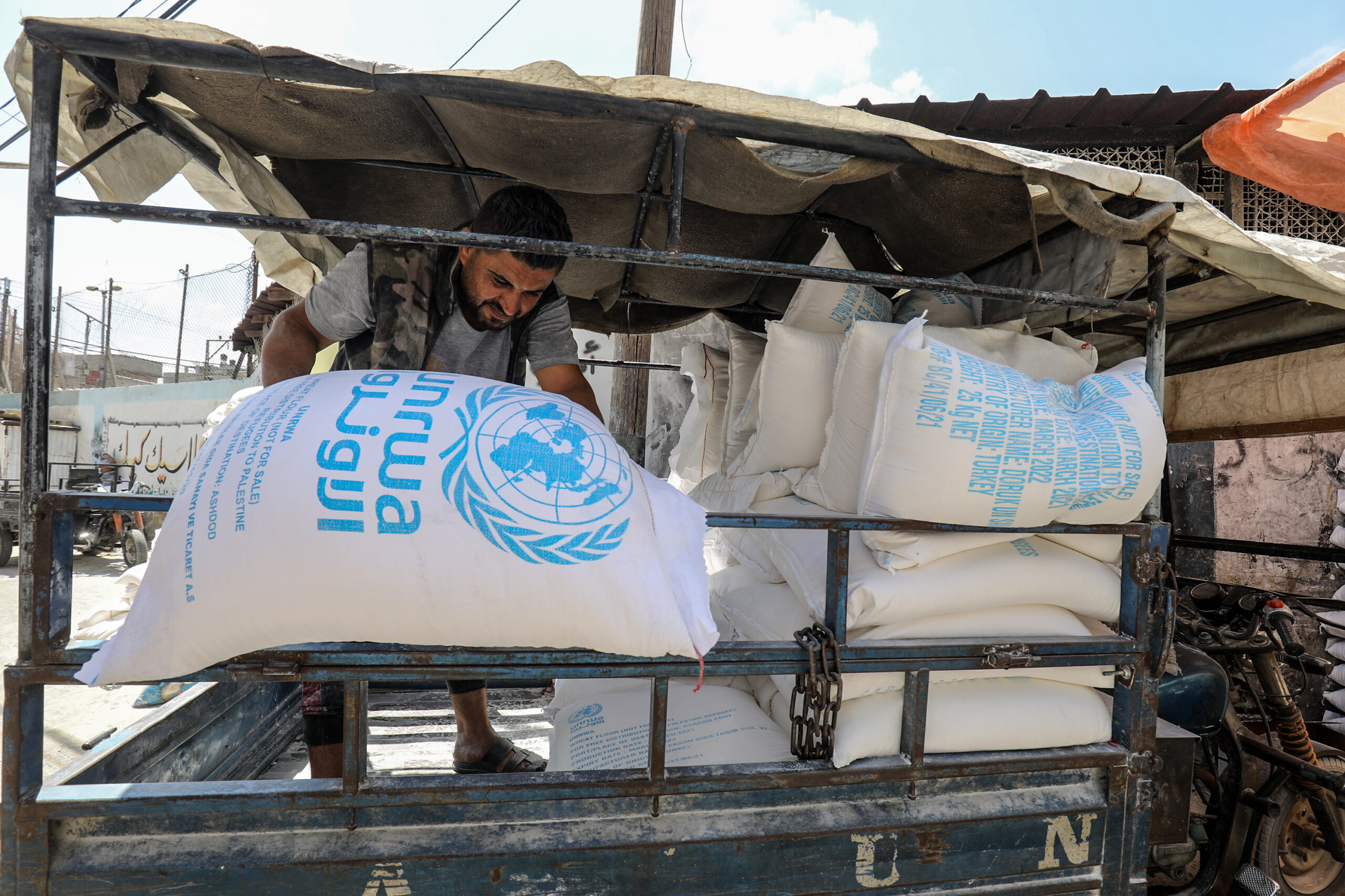 Palestinians receive food aid at a United Nations Distribution Center