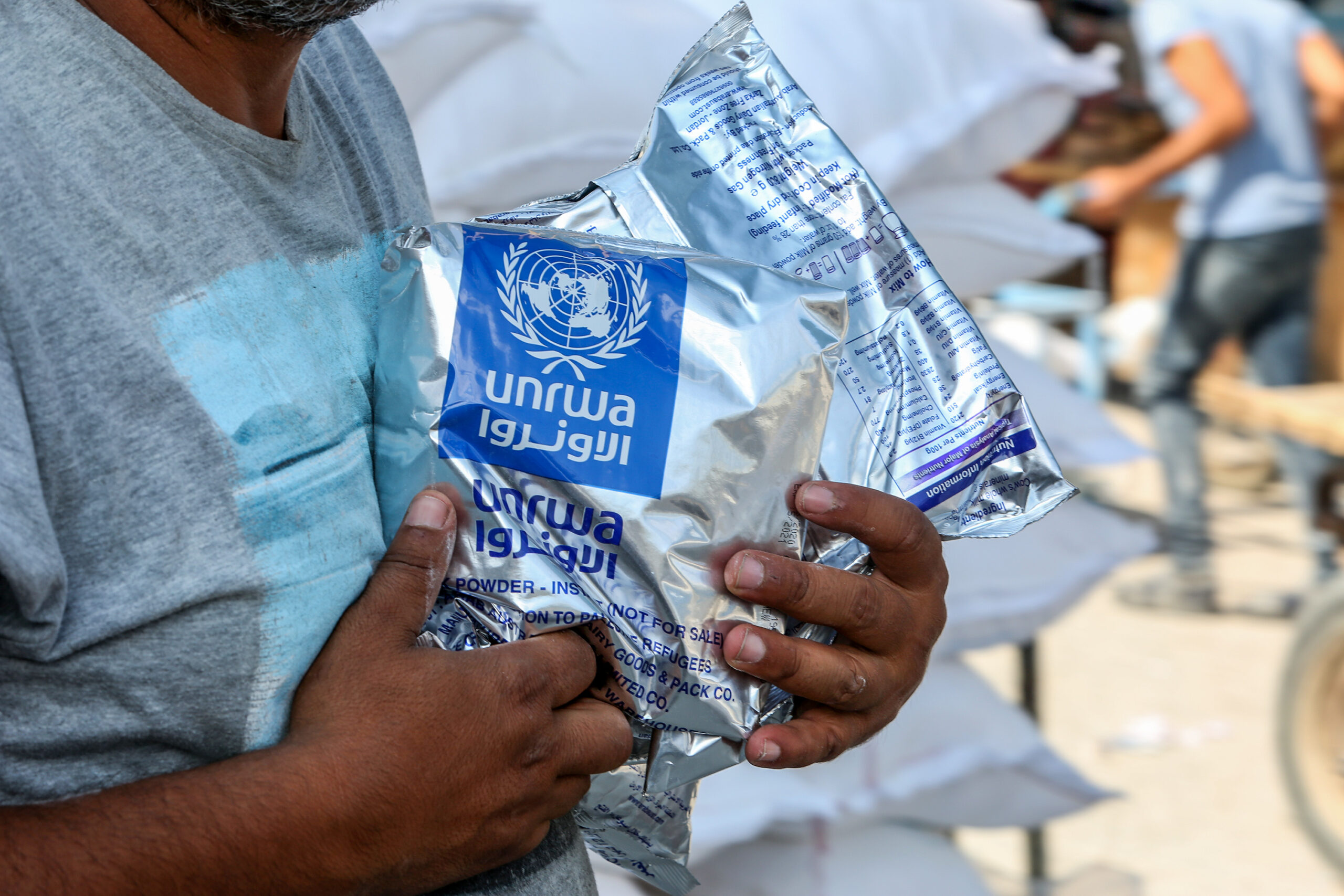 Palestinians come to receive food aid from UNRWA